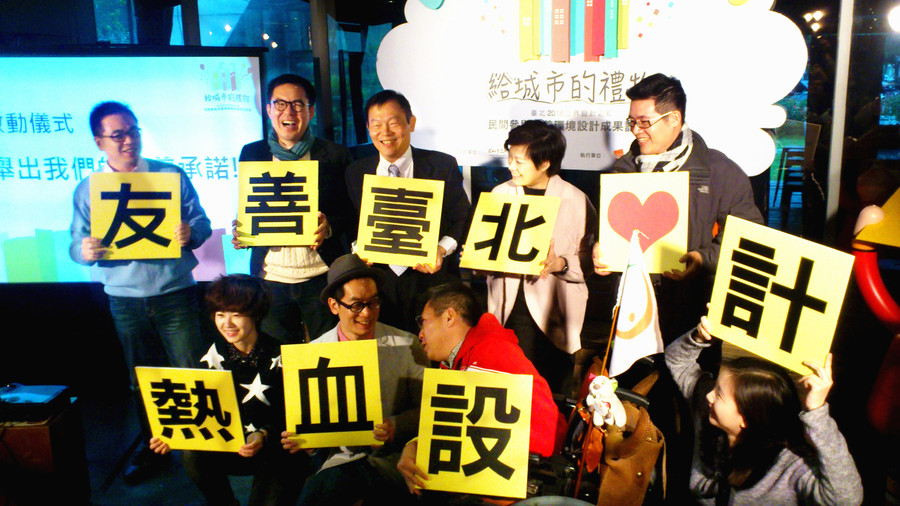 參與友善環境設計的官員與年輕設計師們一起展示活動標語。(photo by 彭書穎/台灣醒報)