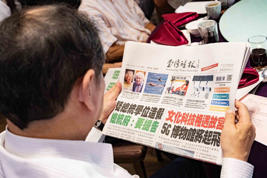 台灣醒報11周年慶現場,與會者津津有味閱讀醒報。(photo by 施銘成)